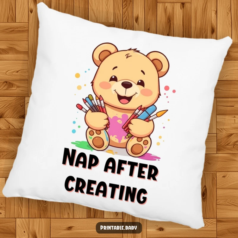 Funny smiling teddy bear pillow, holding art supplies with paint splatters, offering comfort and a creative, artistic touch.
