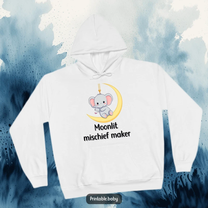 Funny hoodie with a tiny elephant gleefully swinging from a crescent moon, offering warm, humorous, and magical comfort.